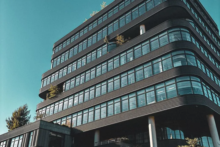 Modern multi-storey commercial office building with a glass facade